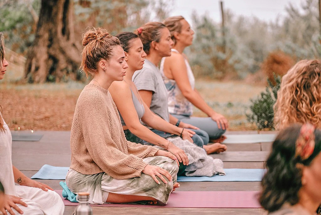 solo yoga retreats for women - group of women doing yoga