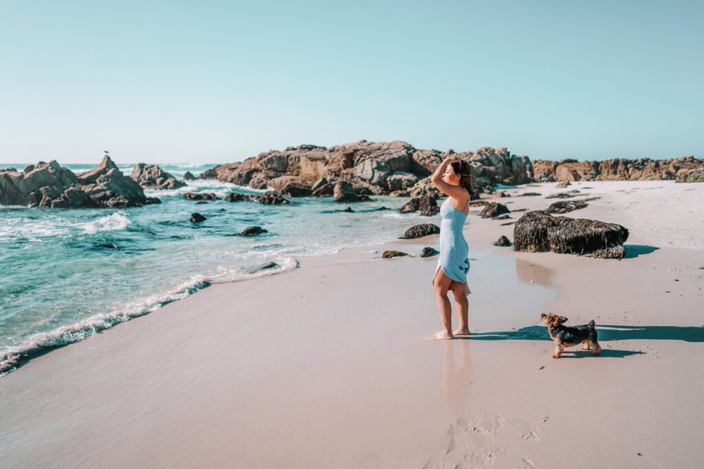 Woman on the beach with a dog