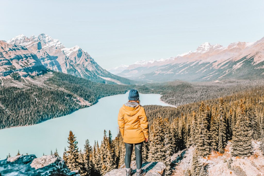 solo female travel in canada - woman looking at mountains and lake